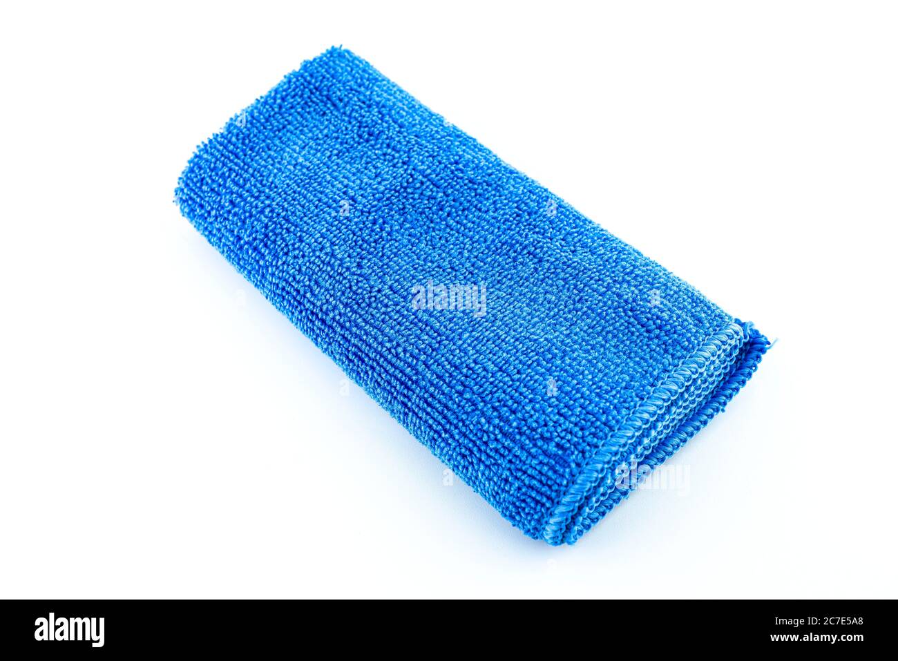 Blue microfiber fabric lying in the middle, isolated on a white