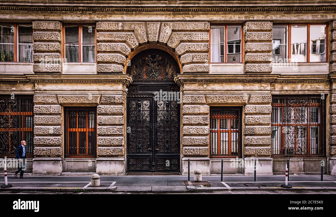 Budapest, Hungary, Aug 2019, view of a man in hurry passing by an old building in the centre of the capital Stock Photo