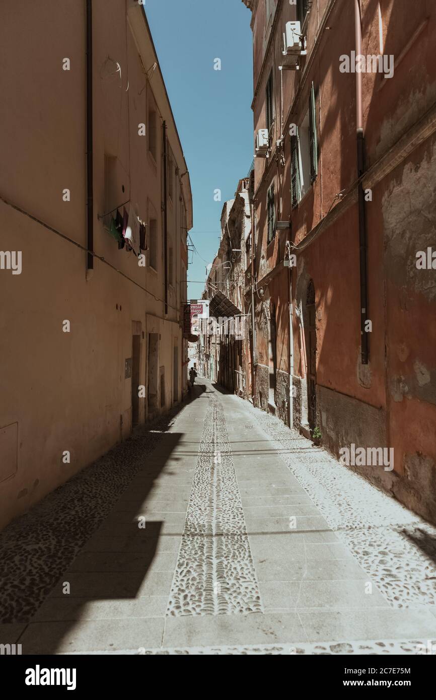 Vertical Shot Of An Empty Alleyway In The Middle Of Buildings Under A Blue Sky At Daytime Stock Photo Alamy Vertical Shot Of An Empty Alleyway In The Middle Of Buildings Under A Blue Sky At Daytime Stock Photo Alamy