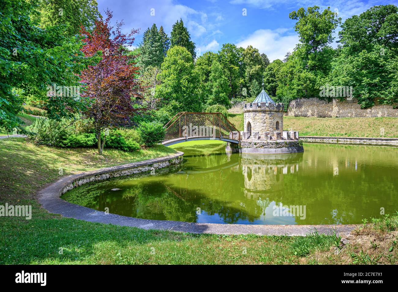 Love Lock Bridge leading to small Roundhouse in water pond in Bojnice castle park (Bojnice, Slovakia) Stock Photo