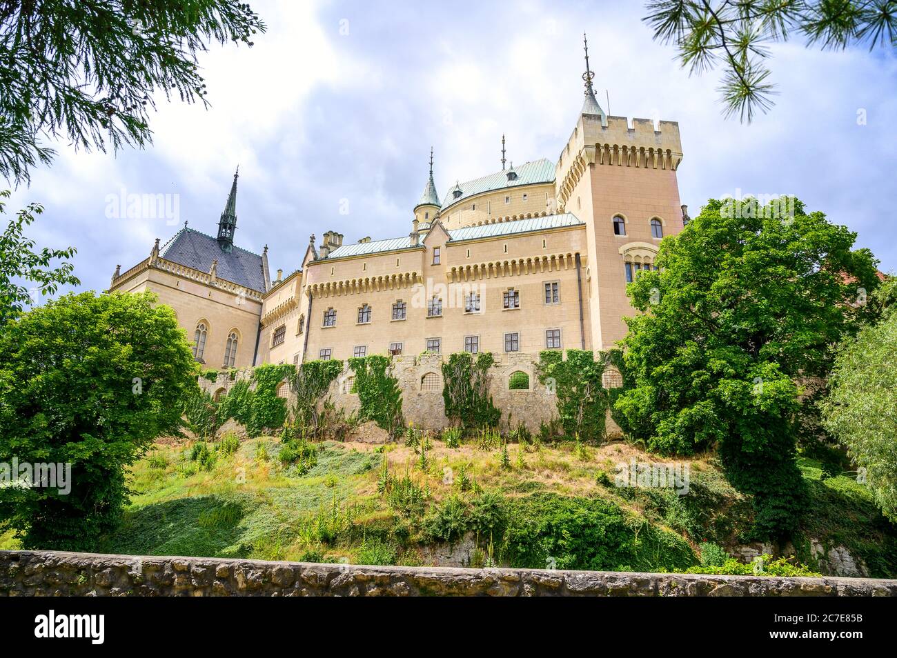 View of neogothic Bojnice castle with small fortification wall from Castle park (Bojnice, Slovakia) Stock Photo