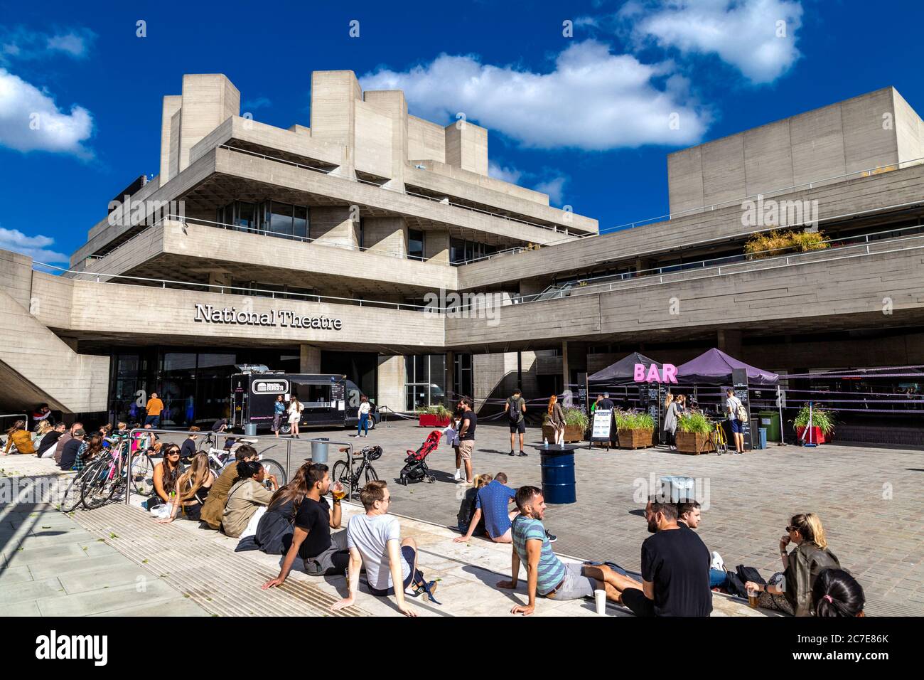 People socialising and food market stalls in front of the National Theatre, Southbank, London, UK Stock Photo