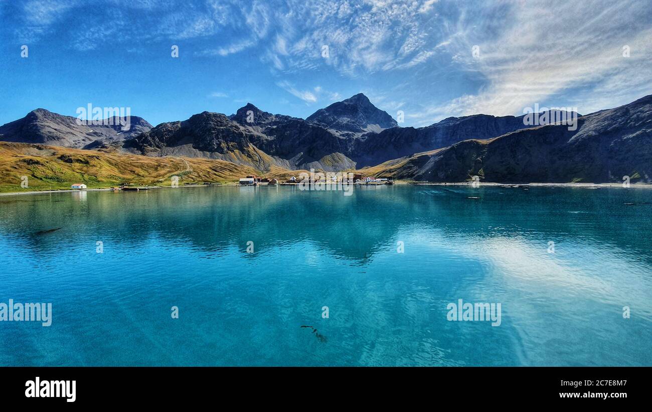 Dramatic landscape shot of Grytviken in South Georgia with blue skies and turquoise water Stock Photo