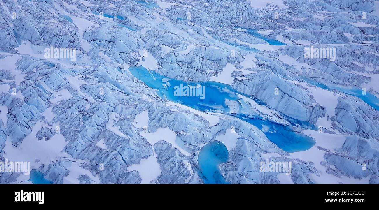 Wide aerial of glacier in greenland with glacial rivers and lakes Stock Photo