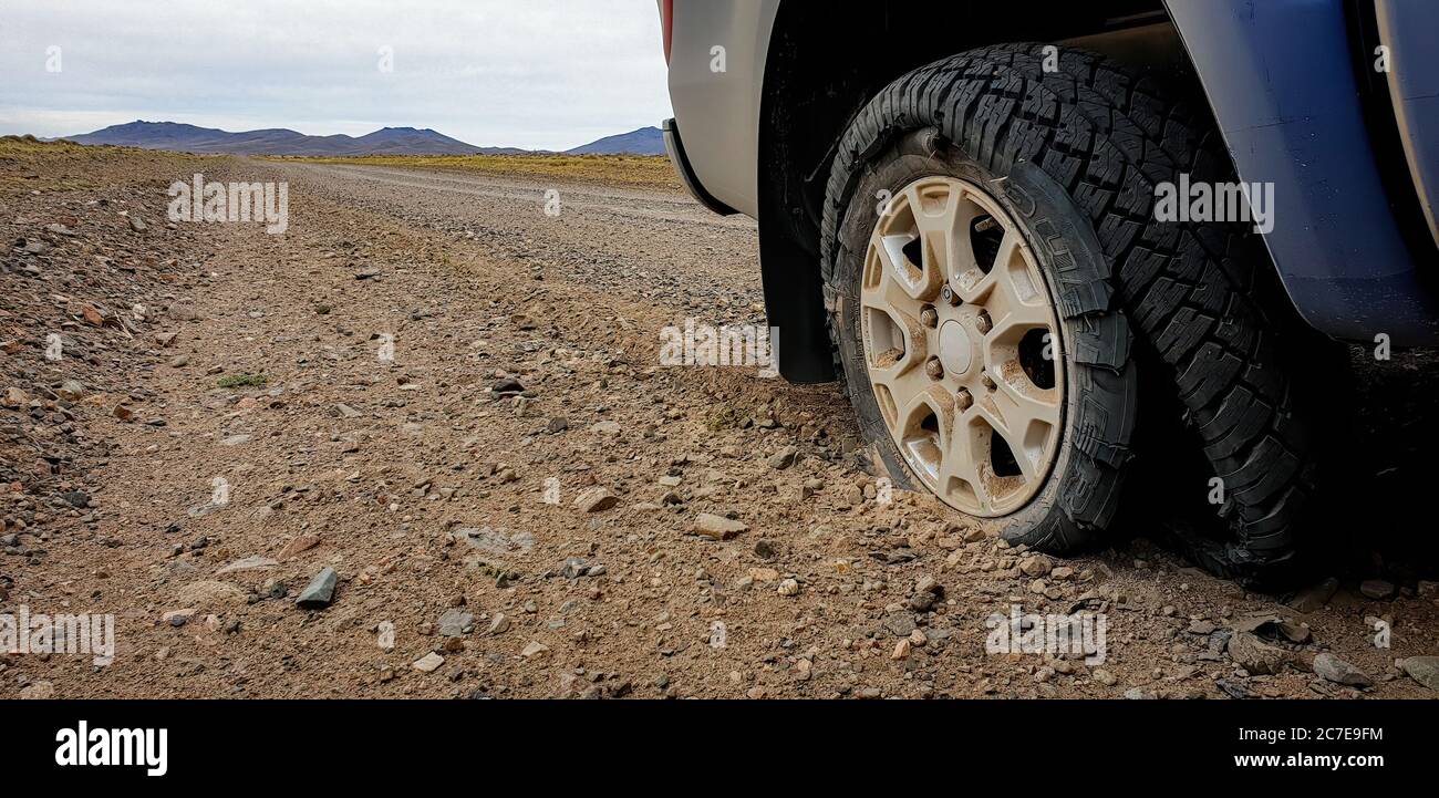 Burst tyre on dirt road in Patagonia Stock Photo