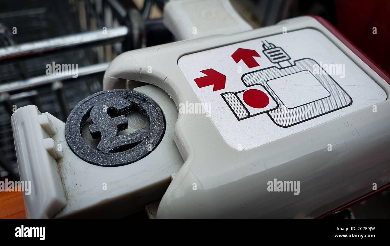 Pound sterling shape coin in a shopping trolley cart Stock Photo