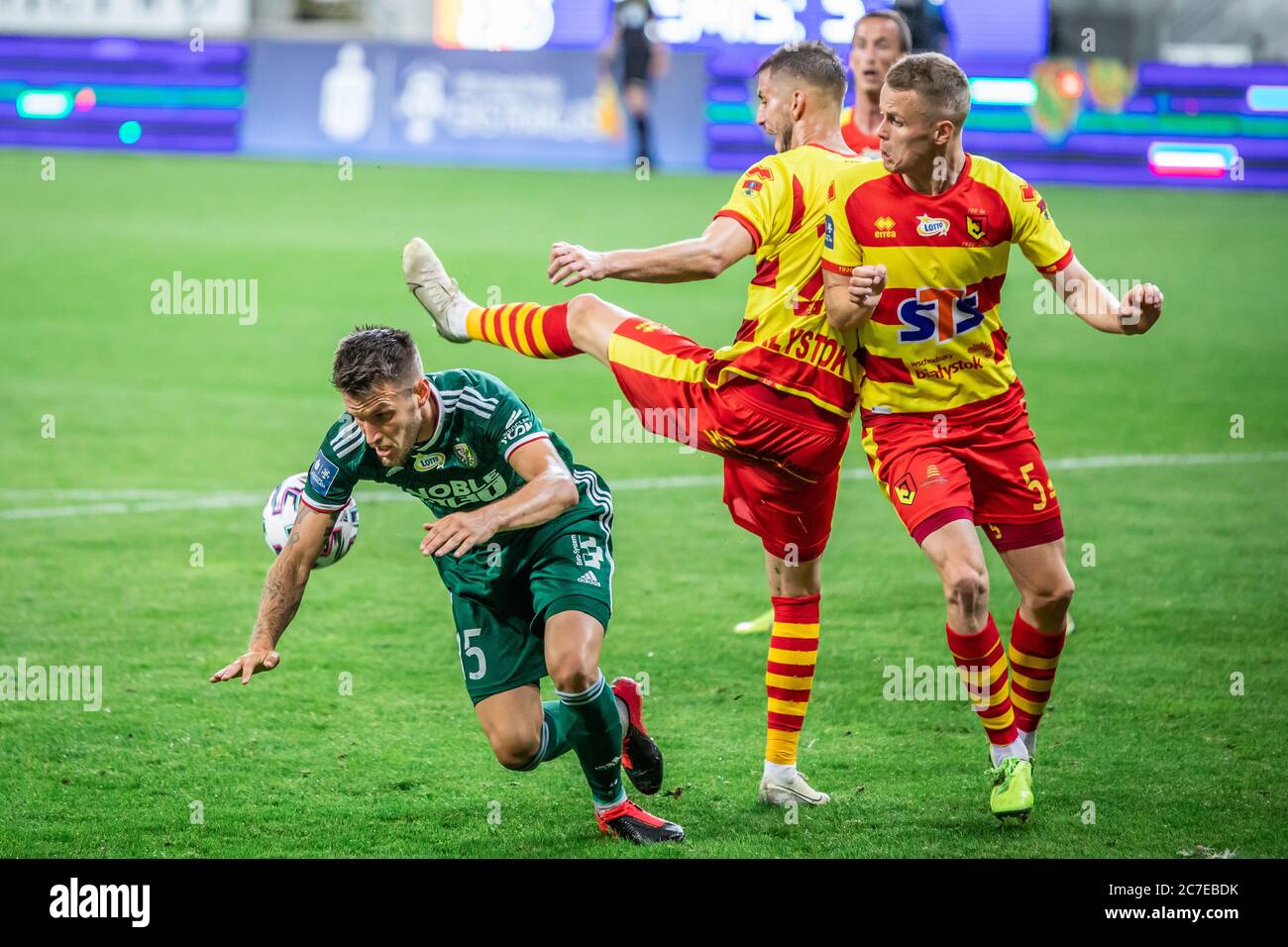 Mark Tamas of Slask Wroclaw, Jakov Puljic and Dawid Szymonowicz of  Jagiellonia Bialystok are seen in action during the Polish PKO Ekstraklasa  match between Jagiellonia Bialystok and Slask Wroclaw at Bialystok City