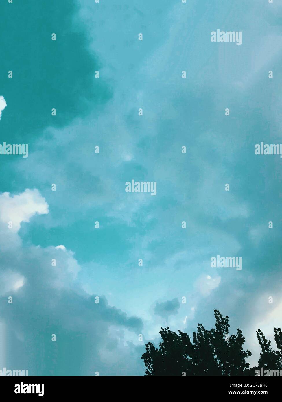Vertical low angle shot of the breathtaking cloudy sky - perfect for a ...
