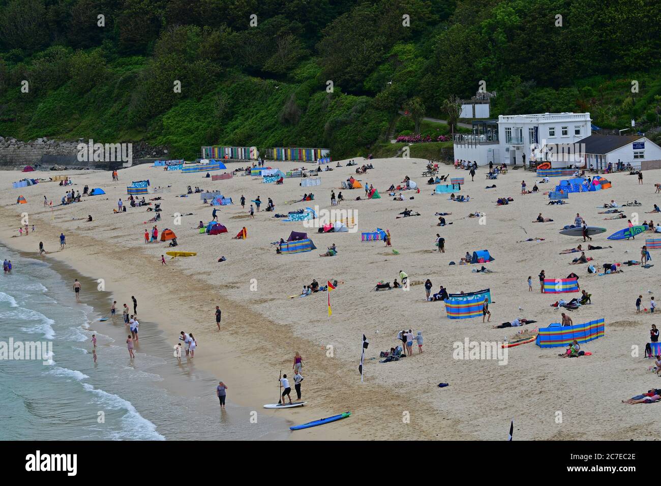 St Ives, UK. 16th July, 2020. 16th July 2020.Lazy afternoon on a Packed beach in, Carbis Bay, Cornwall on a hot afternoon. World Leaders will hold a G7 meeting here Next Year July 2021.Picture Credit: Robert Timoney/Alamy Live News Stock Photo