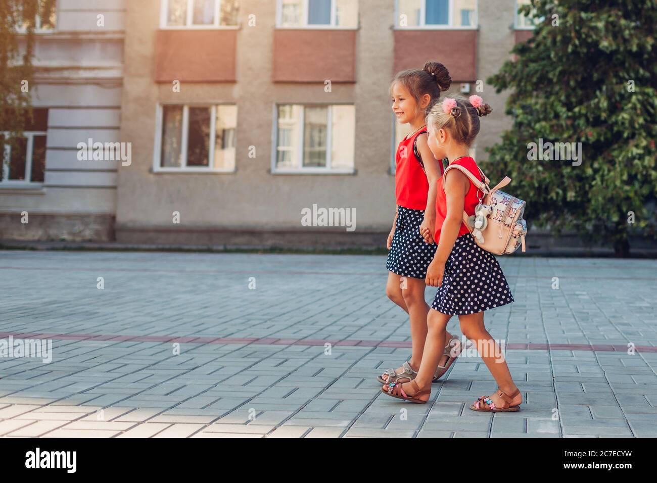 Two children holding hands school hi-res stock photography and images ...