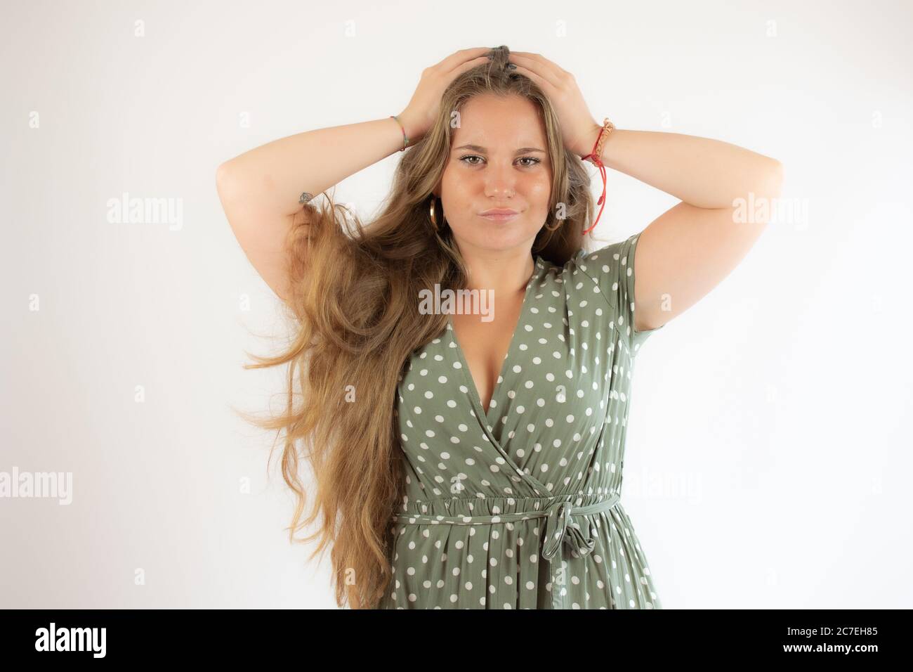Pretty blonde girl in a green dress with the gesture of concern Stock ...