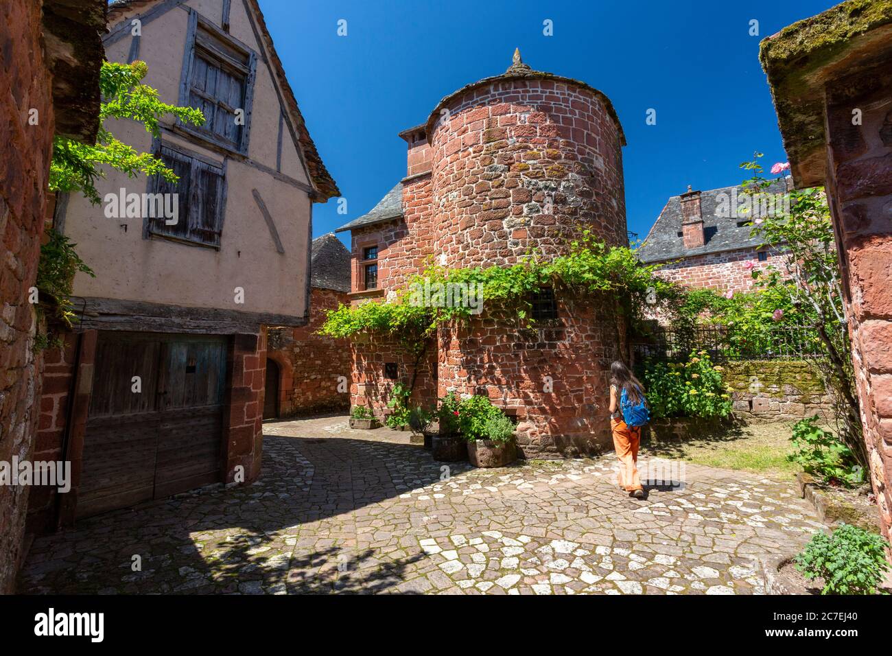 A female tourist walking in the red sandstone village Collongesla