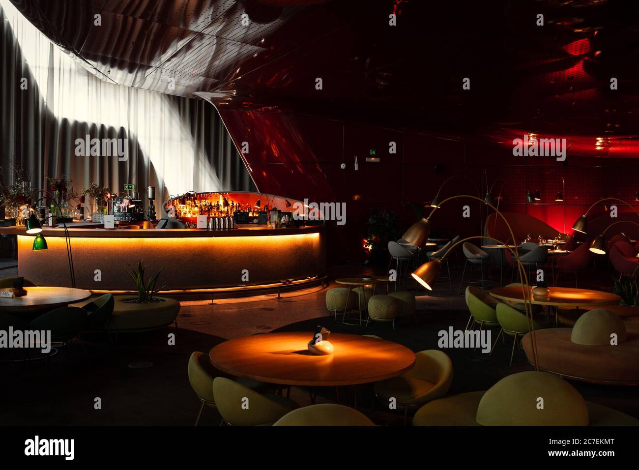 Interior shot of a futuristic restaurant with a bar table and red ...