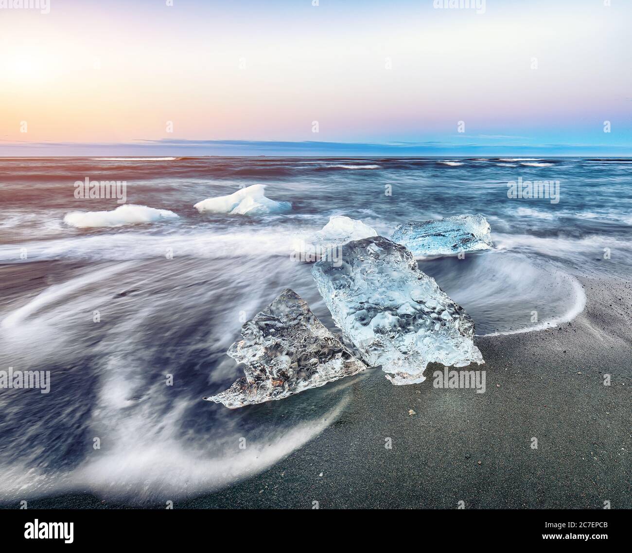Incredible pieces of the iceberg sparkle on famous Diamond Beach at Jokulsarlon lagoon during