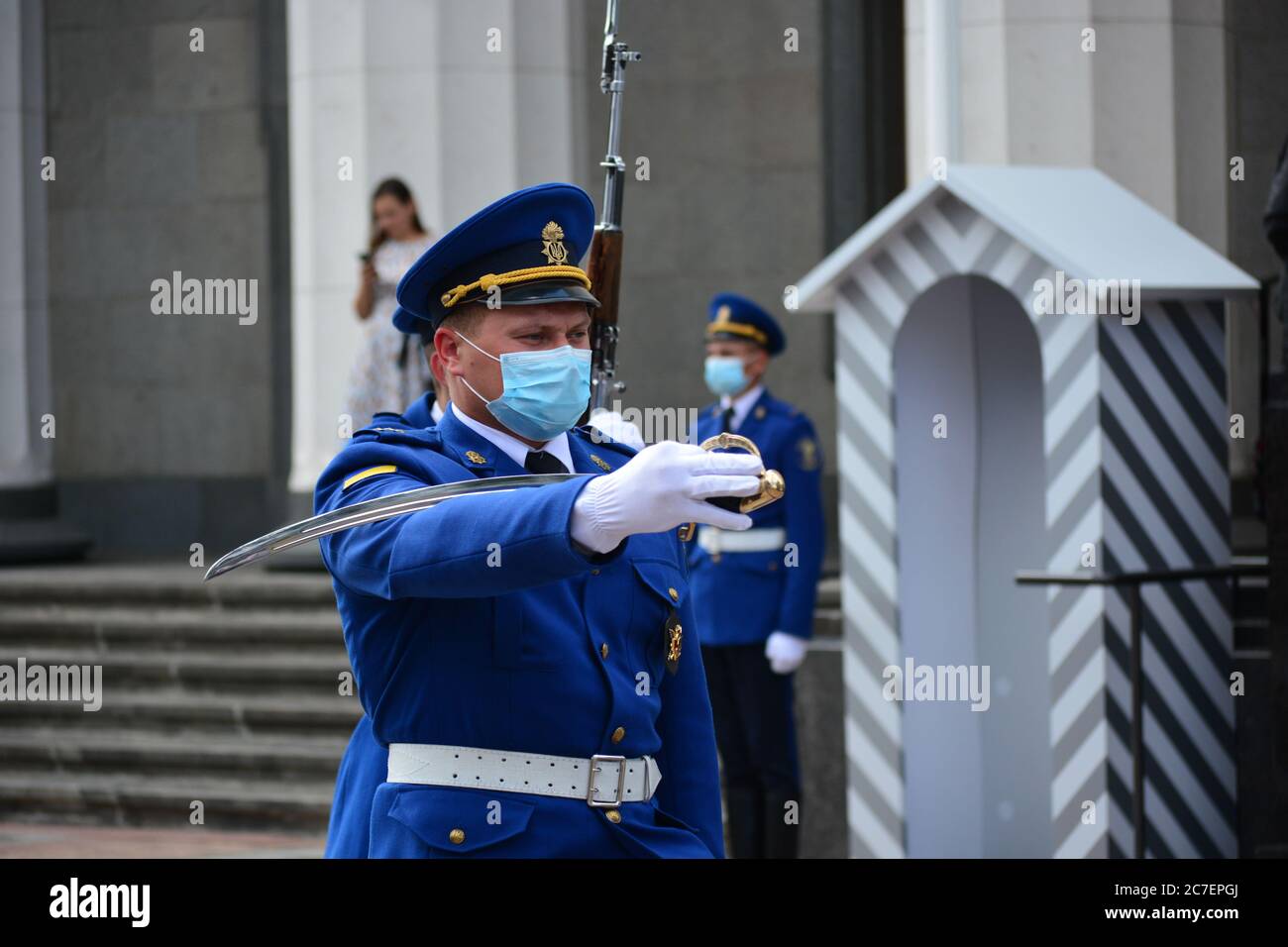 Coronavirus outbreak: Guard change ceremony near the building of the Ukrainian Parliament in Kyiv. Guardsmen wear protective face masks. Stock Photo
