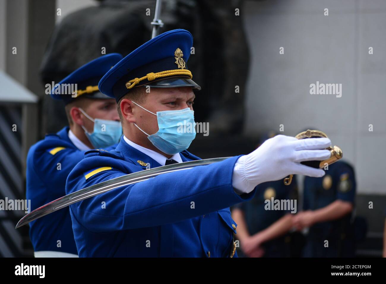 Coronavirus outbreak: Guard change ceremony near the building of the Ukrainian Parliament in Kyiv. Guardsmen wear protective face masks. Stock Photo