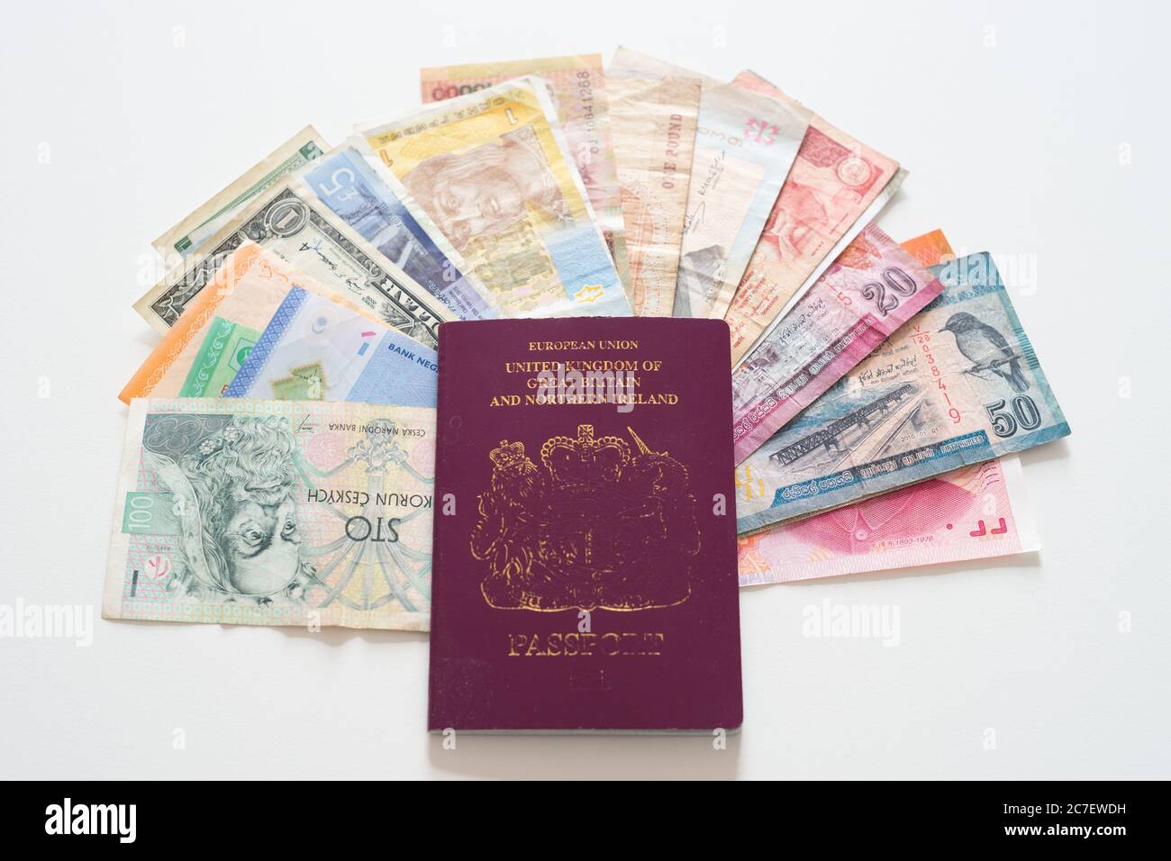 Red UK European Union passport with various currencies from countries around the world, concept - travel, see the world Stock Photo