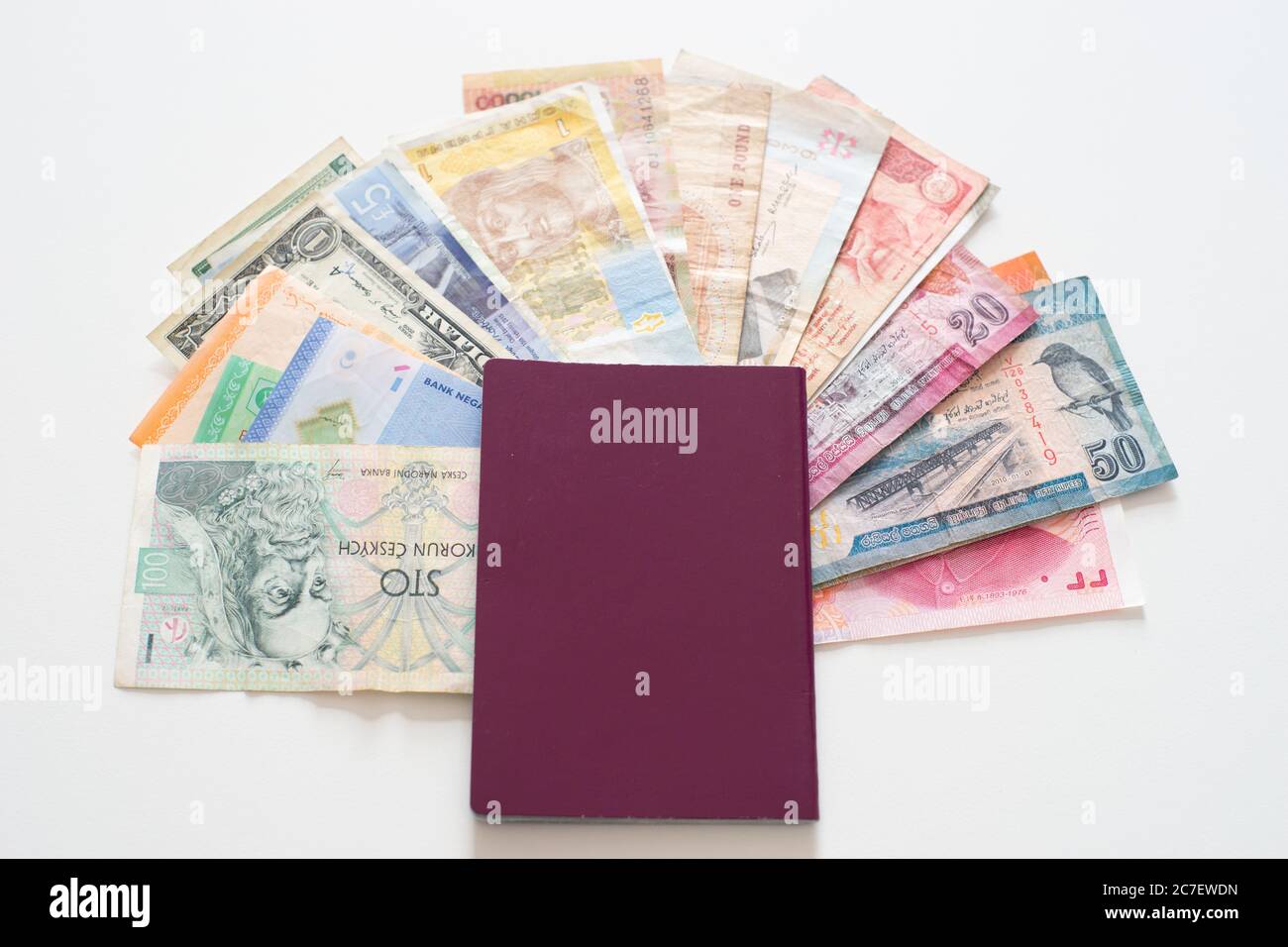 Red passport with various currencies from countries around the world, concept - travel, see the world Stock Photo