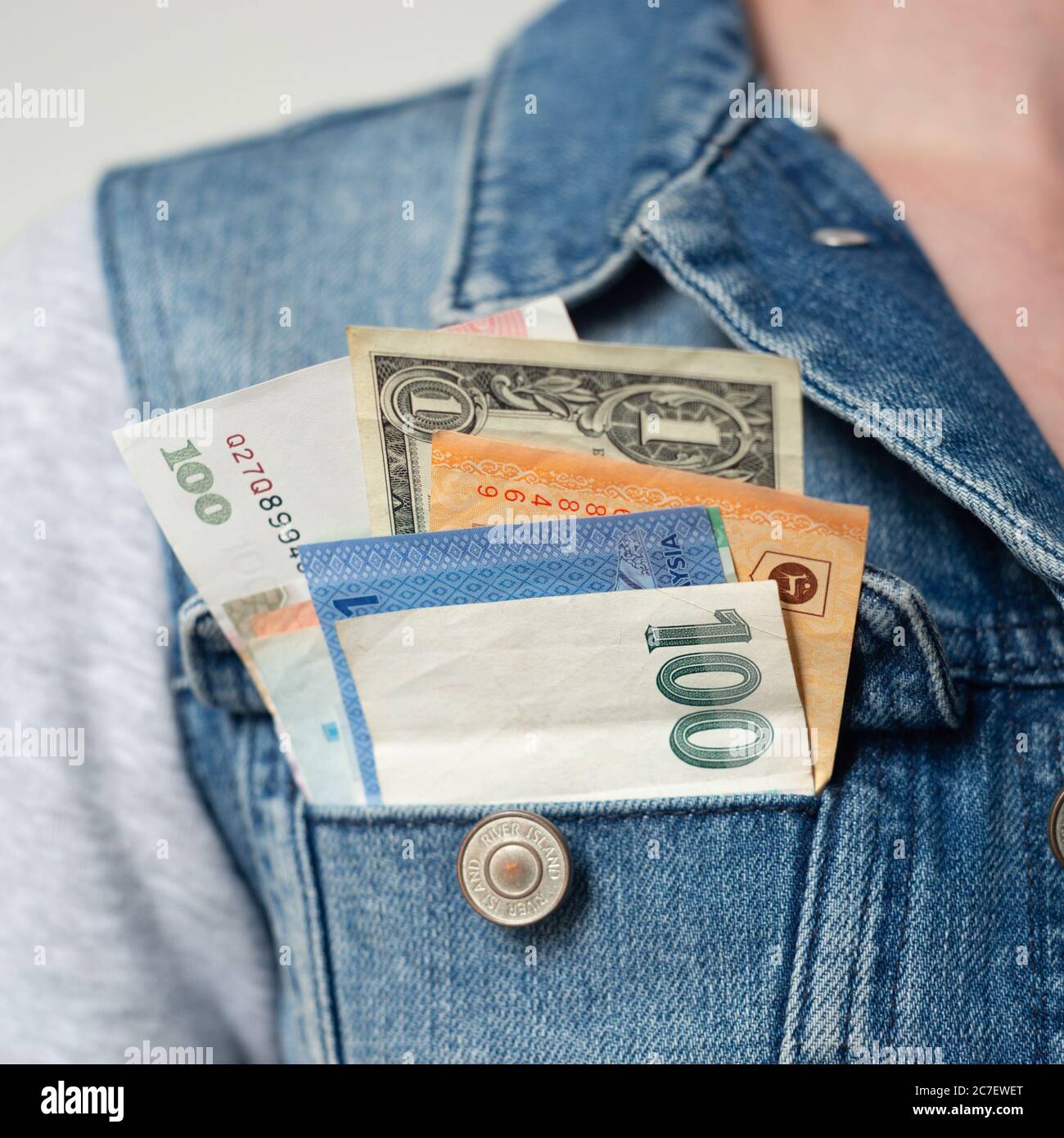 Banknotes or bills of various currencies in pocket, concept, travel, traveller, around the world, trip, globetrotter, see the world, vacation, holiday Stock Photo
