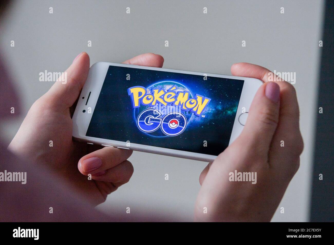 Los Angeles, California, USA - 8 March 2019: Hands holding a smartphone with Pokemon Go game on display screen, Illustrative Editorial Stock Photo