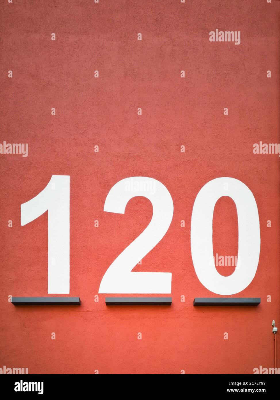 Vertical shot of a red surface with the number 120 printed  on it Stock Photo