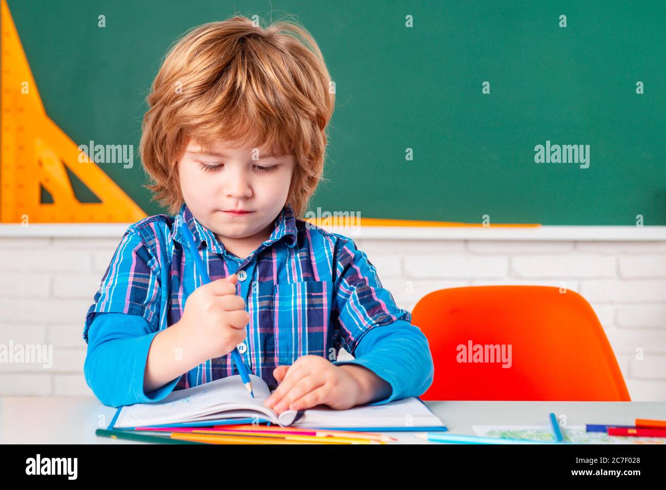 Schoolkid or preschooler learn. Cute child boy in classroom near blackboard desk. Kids from primary school. Happy school kids at lesson Stock Photo Alamy