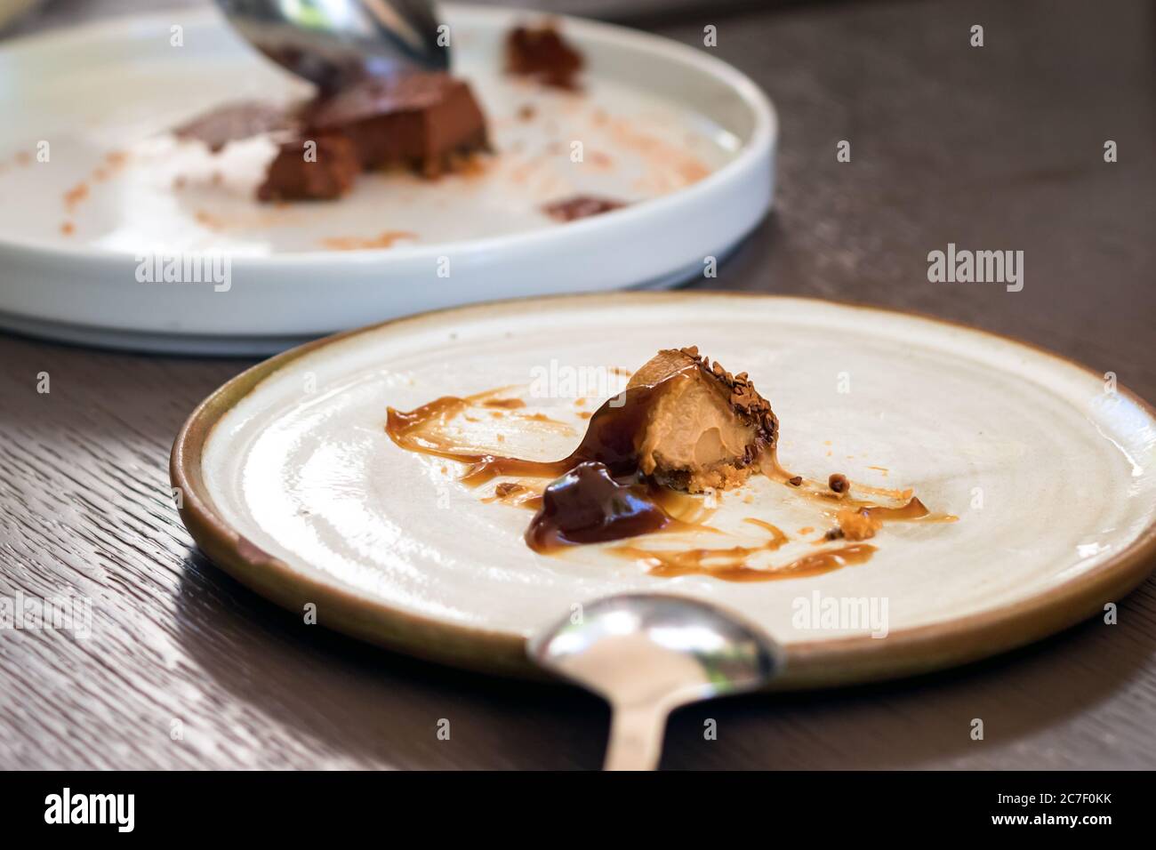 A plate with a gourment dessert leftover on a table Stock Photo