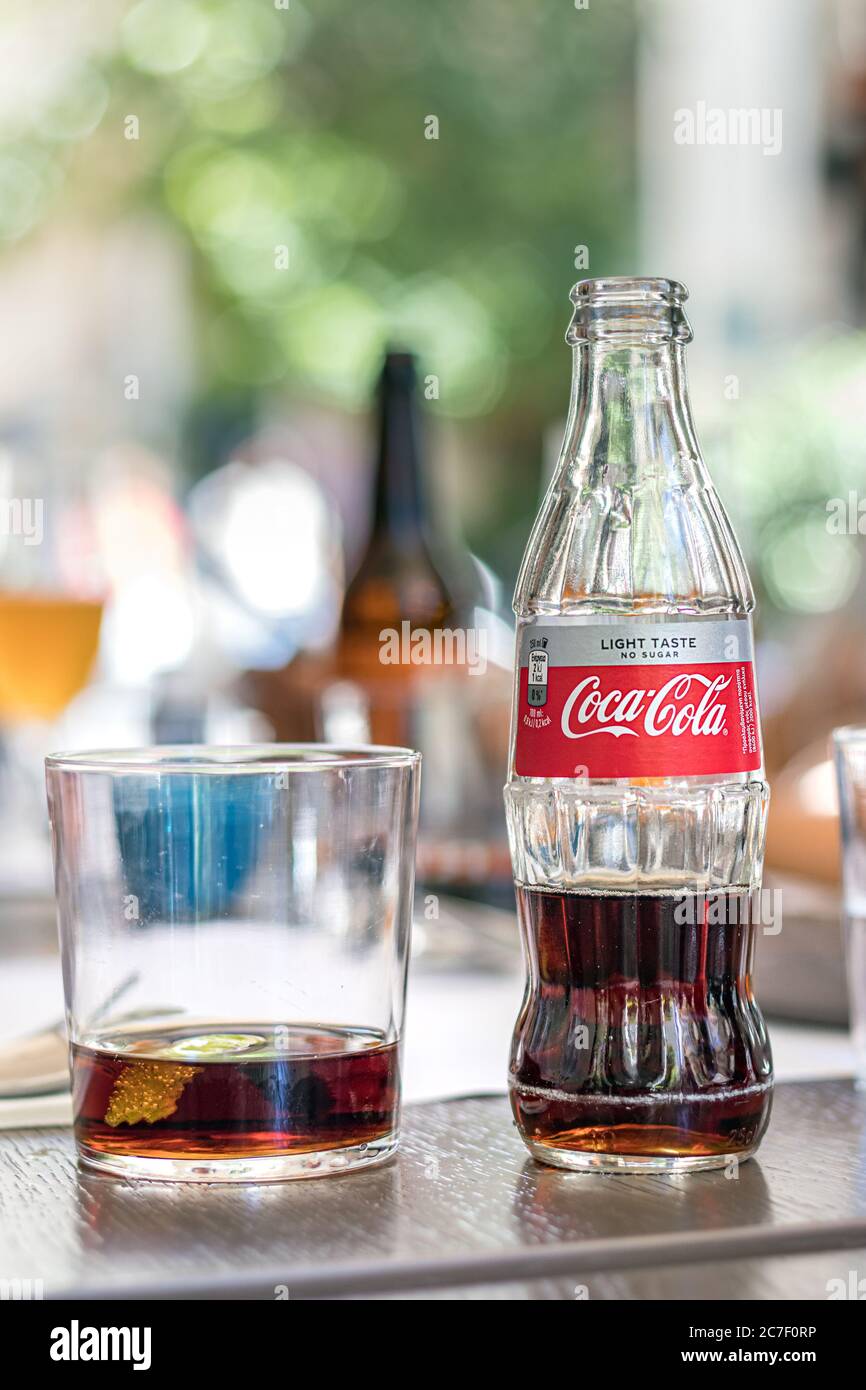 A glass bottle of Coca Cola light taste on a table outdoors Stock Photo -  Alamy