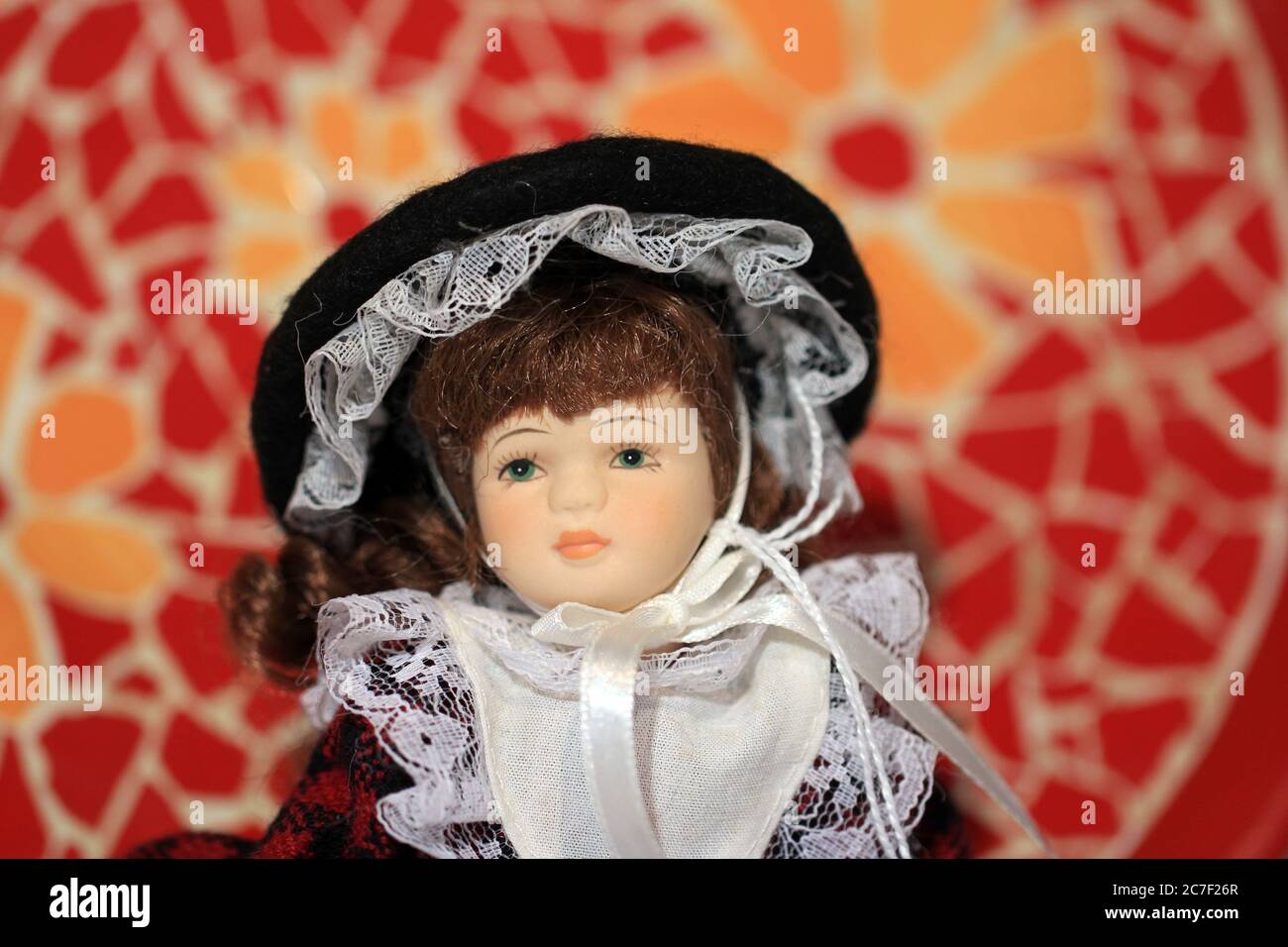 Horizontal shot of a porcelain doll in a white and black dress in a charity store Stock Photo