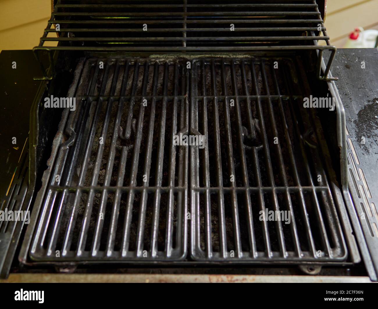 Empty gas grill top used for home barbecuing with the lid open. Stock Photo