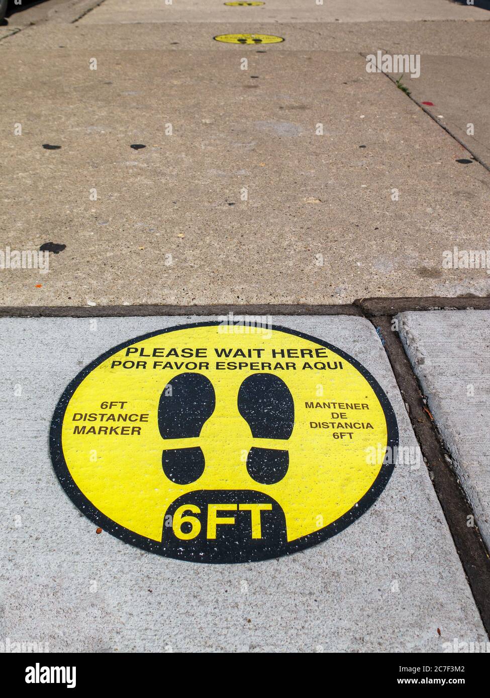 Social distancing marker on sidewalk. Damen Avenue, Wicker Park neighborhood, Chicago, Illinois. Stock Photo