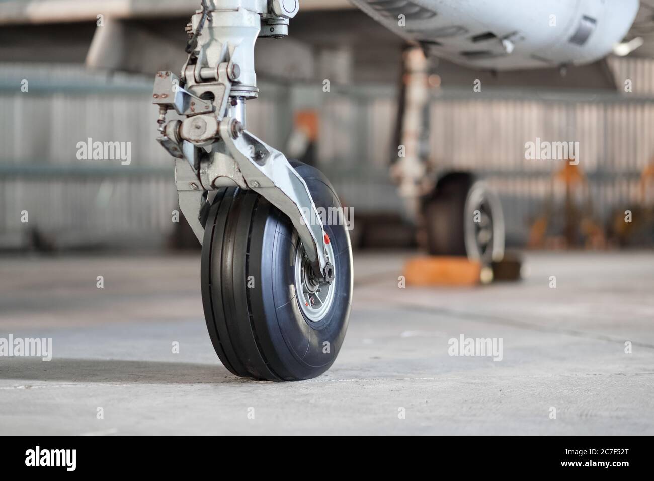 Front landing gear of aircraft on the ground Stock Photo