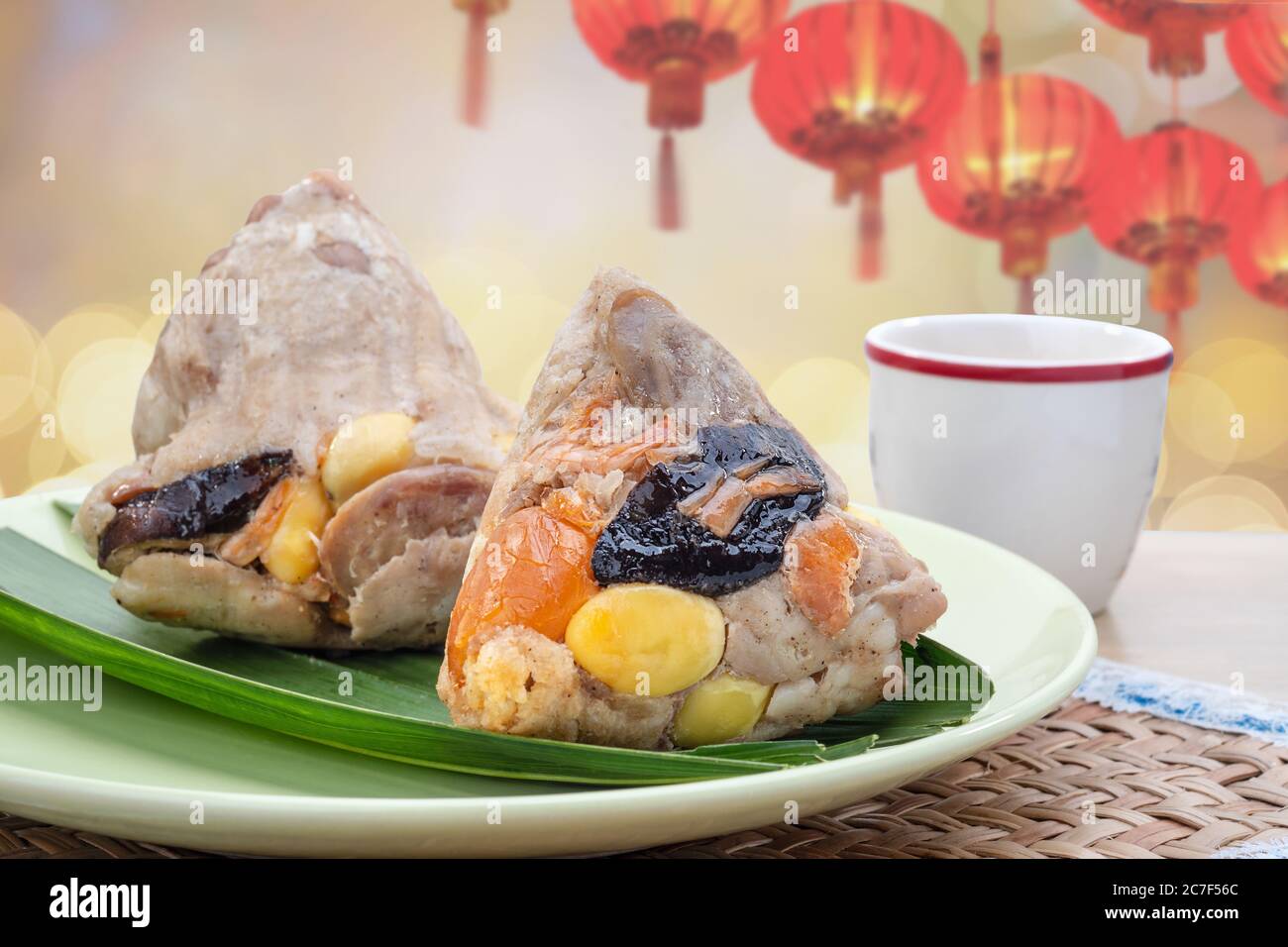 Rice dumplings or zongzi is a traditional Chinese food, made of glutinous rice stuffed with different fillings and wrapped in bamboo or reed leaves. T Stock Photo