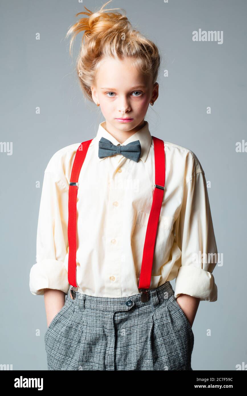 teen girl in retro male suit. retro fashion model. vintage charleston party. jazz step fashion. suspender and bow tie. old fashioned child. vintage Stock Photo