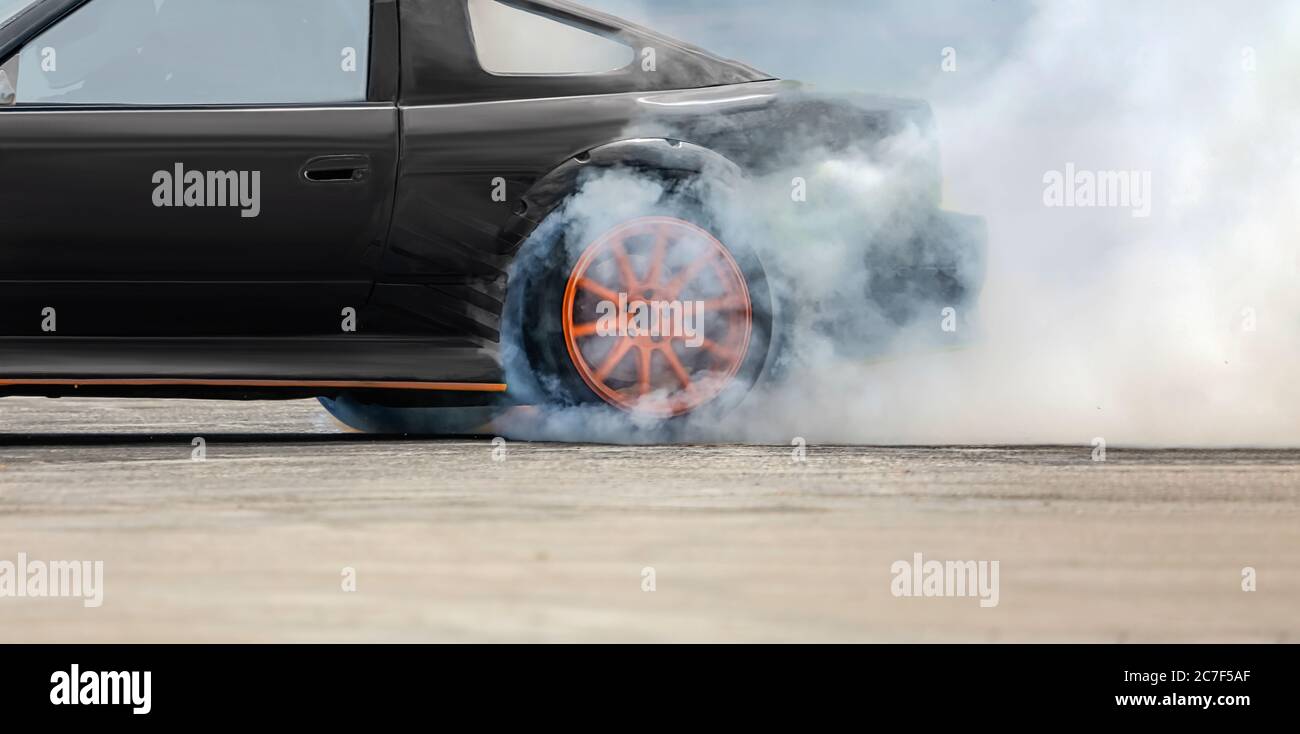 Race drift car burning tires on speed track Stock Photo