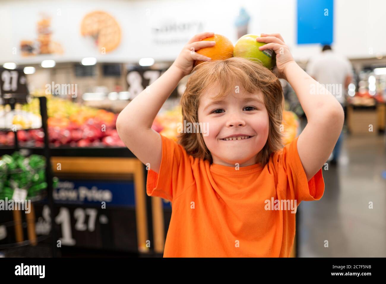 Little boy in the supermarket. Toddler boy with shopping bag in