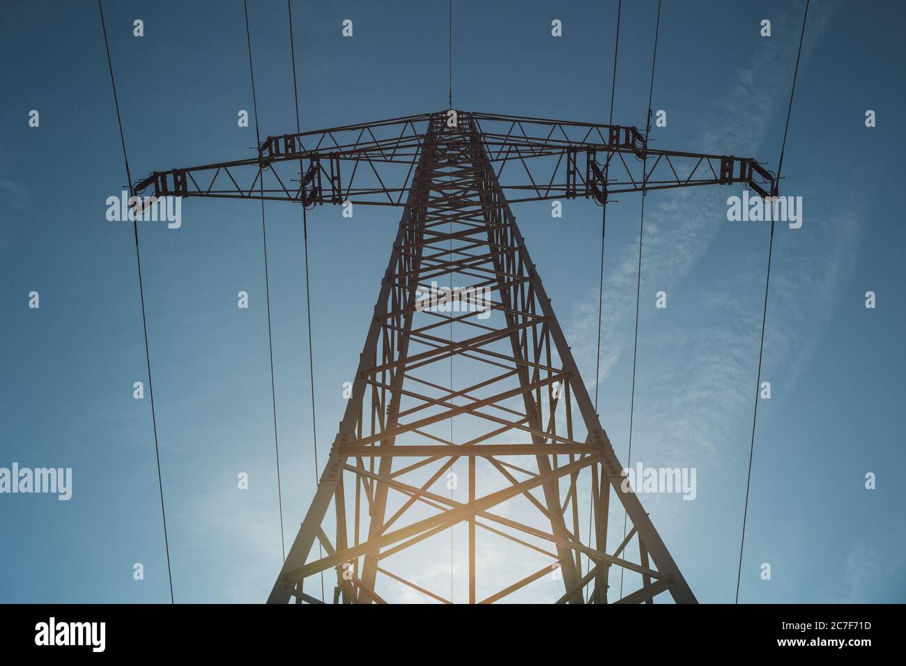 Low angle shot of a tall transmission tower with electric wires Stock ...