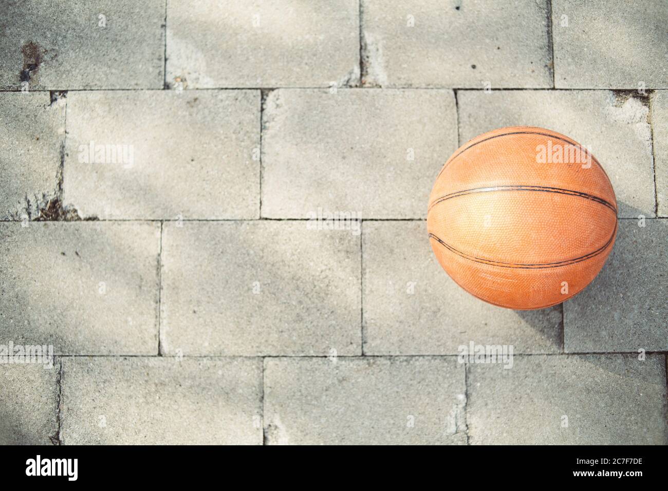 High angle shot of a basketball ball on the pavement Stock Photo