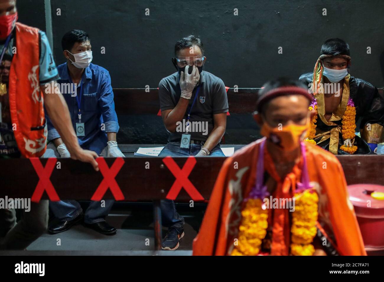 Pranakorn, Thailand. 15th July, 2020. Trainers wearing face masks are seen at the backstage during the Thai Boxing match that was held without spectators as a preventive measure against the spread of COVID-19 coronavirus at Rajadamnern Stadium. Credit: SOPA Images Limited/Alamy Live News Stock Photo