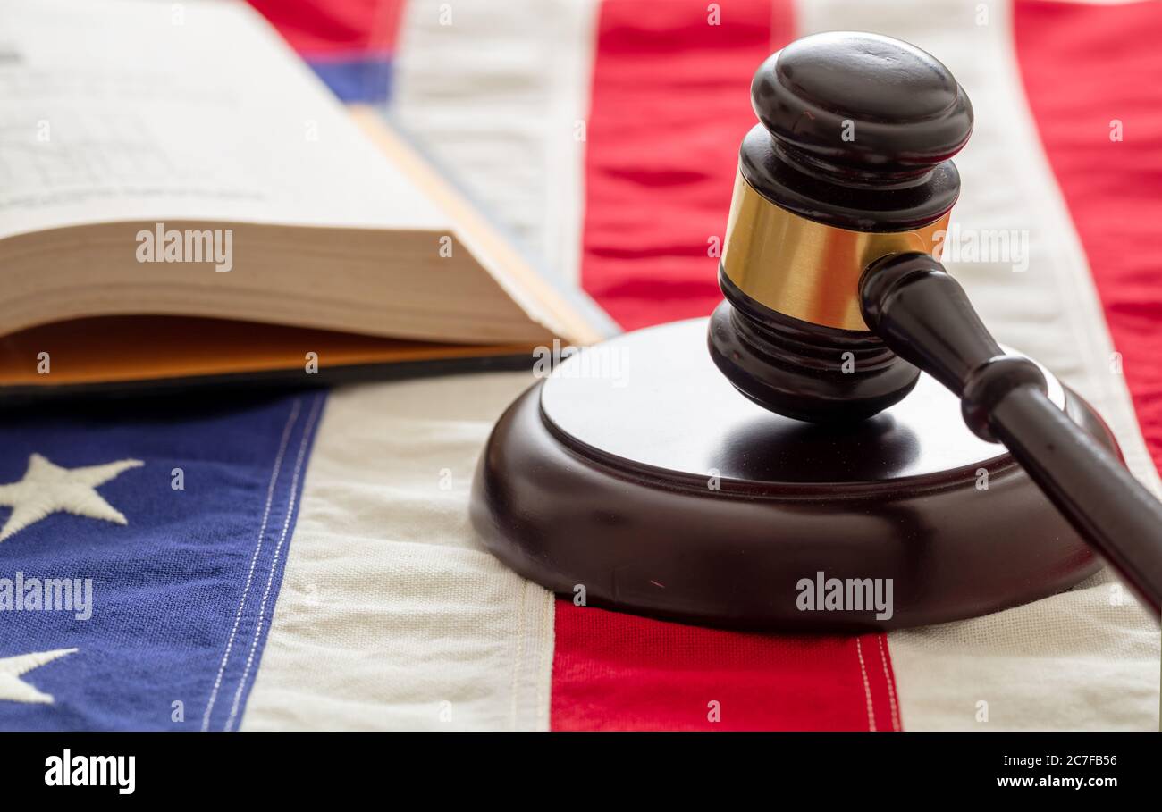 Law studies in USA. Judge gavel and open book on US of America flag background. Justice in USA concept Stock Photo