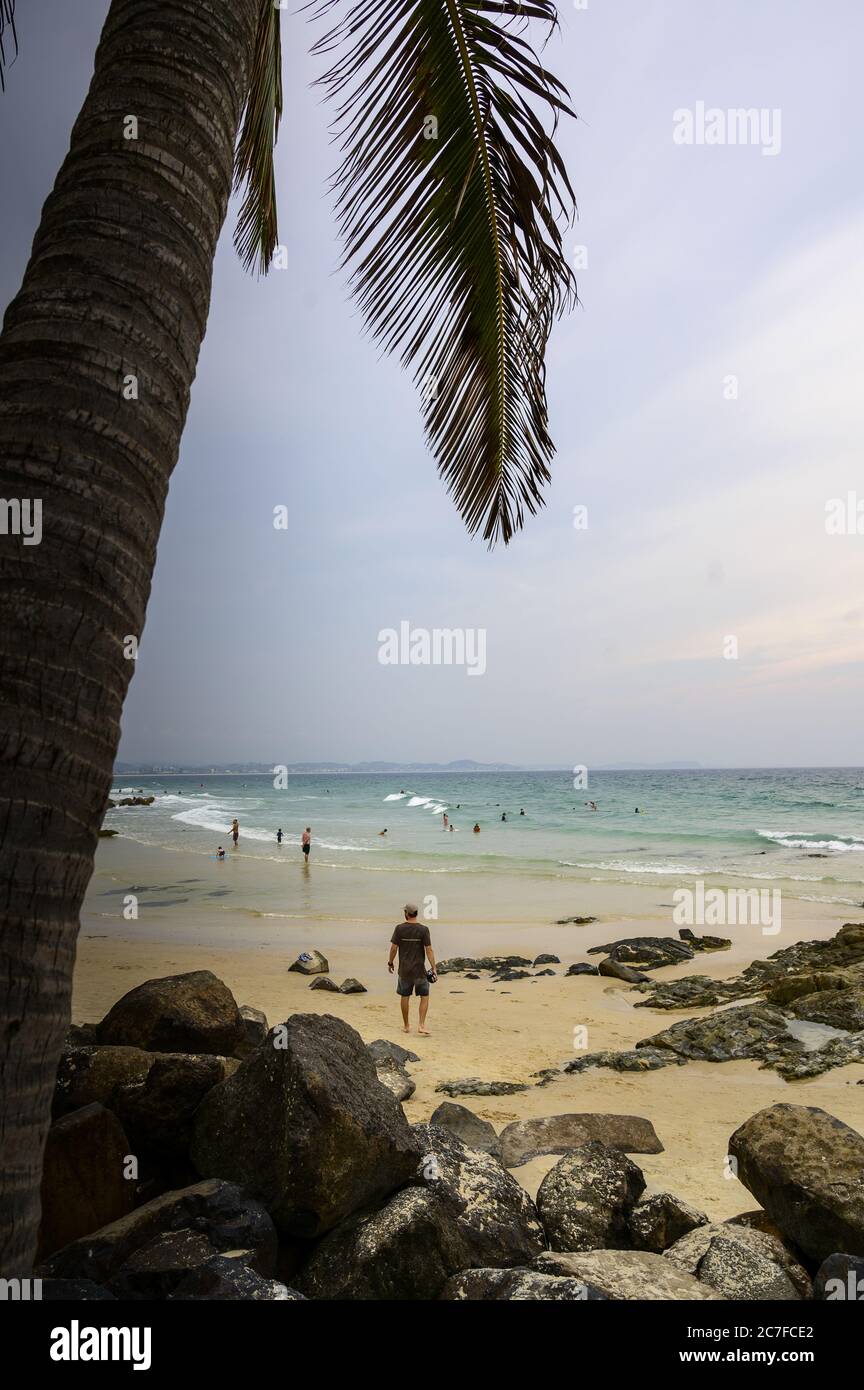 Vertical shot of people near Snapper Rocks in Rainbow Bay, Queensland, Australia Stock Photo