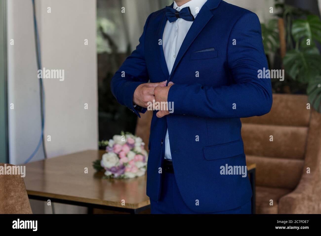 a man in blue suit and bow tie Stock Photo - Alamy