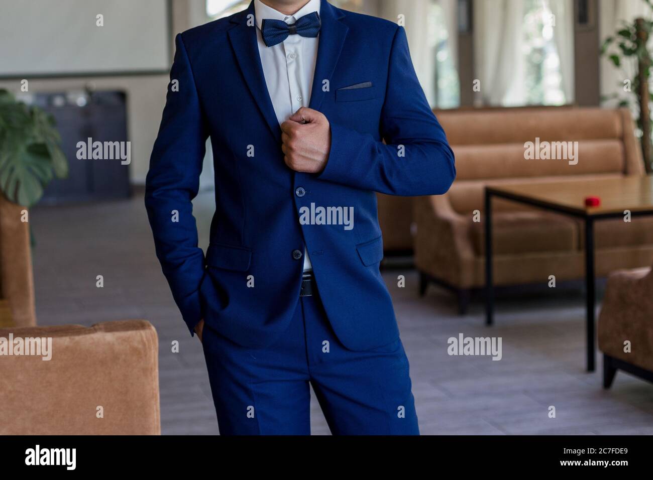 a man in blue suit and bow tie Stock Photo - Alamy