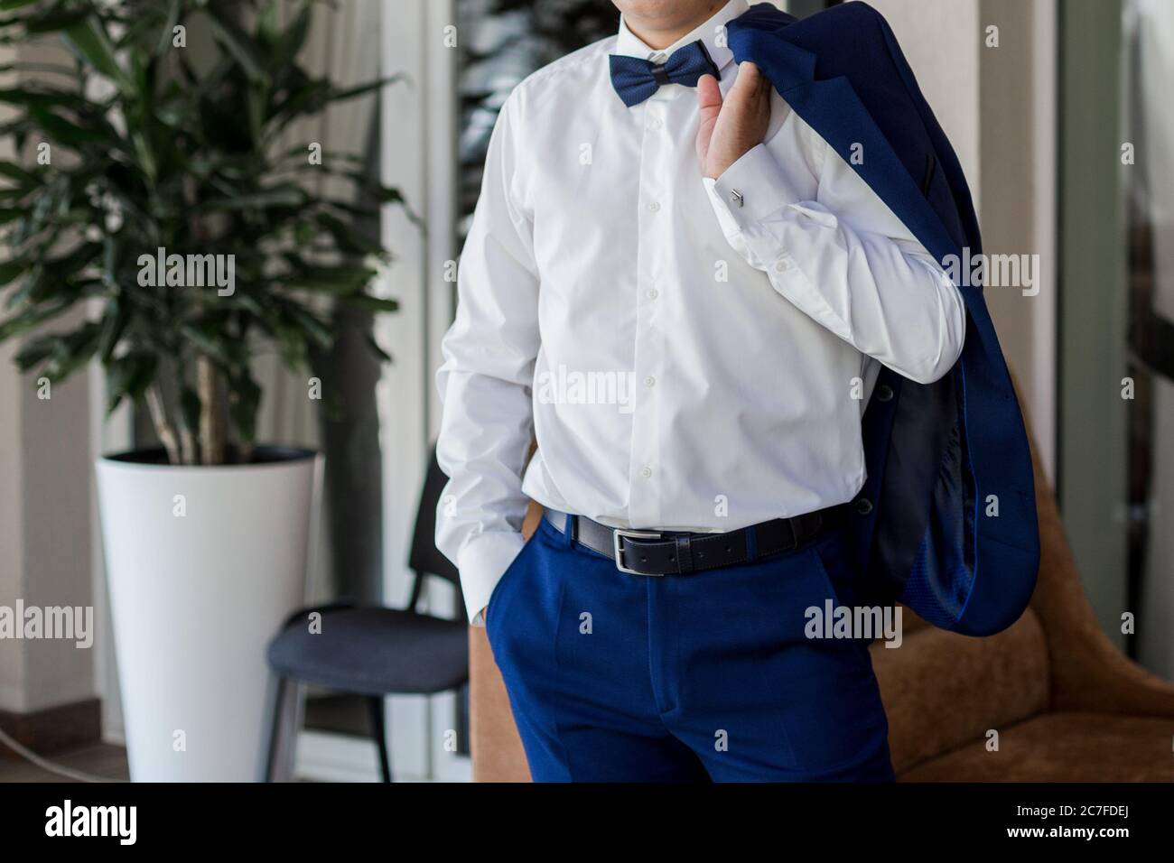 a man in blue suit and bow tie Stock Photo - Alamy