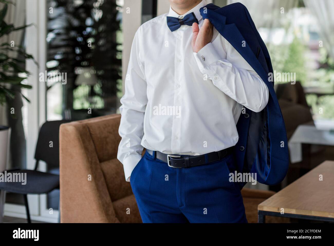 a man in blue suit and bow tie Stock Photo - Alamy