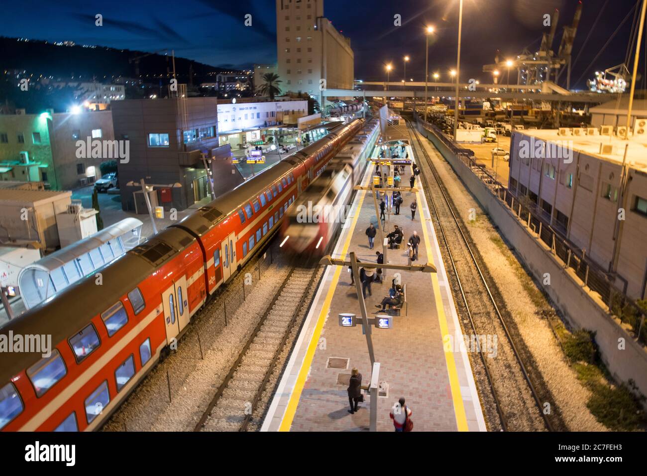 Haifa Train station at night. Haifa port in the background. Haifa, Israel Stock Photo