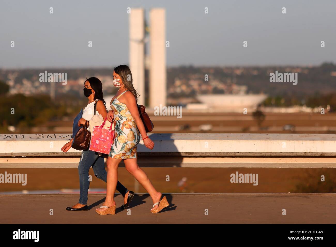 Brasilia, Brazil. 16th July, 2020. Residents wearing face masks walk in Brasilia, Brazil, July 16, 2020. The Brazilian government reported on Thursday that the country has registered over 2 million cases of the novel coronavirus after 45,403 new cases were confirmed in the last 24 hours, for a total of 2,012,151. Credit: Lucio Tavora/Xinhua/Alamy Live News Stock Photo