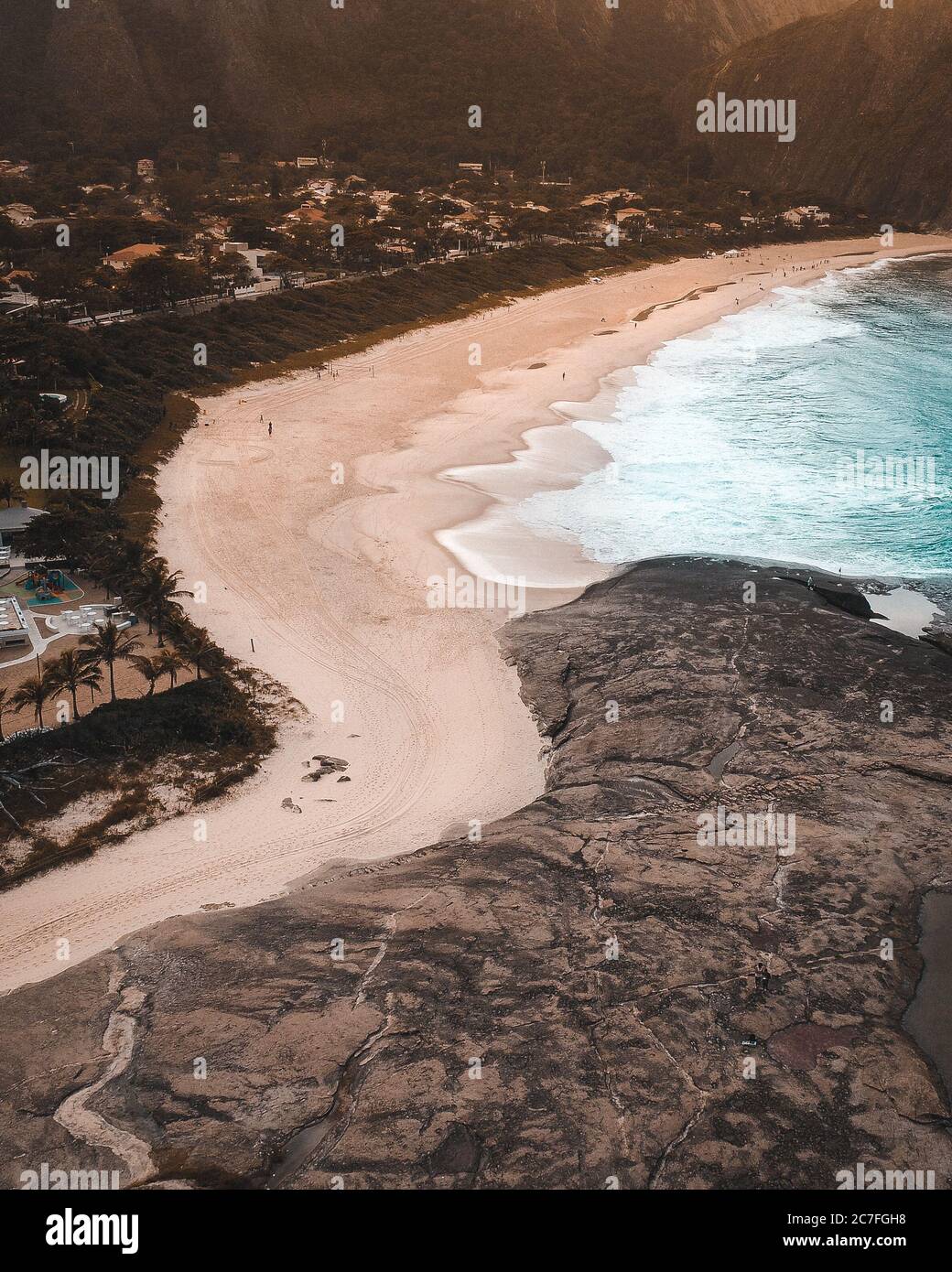 Aerial shot of the ocean waves moving towards the beach in Rio de ...
