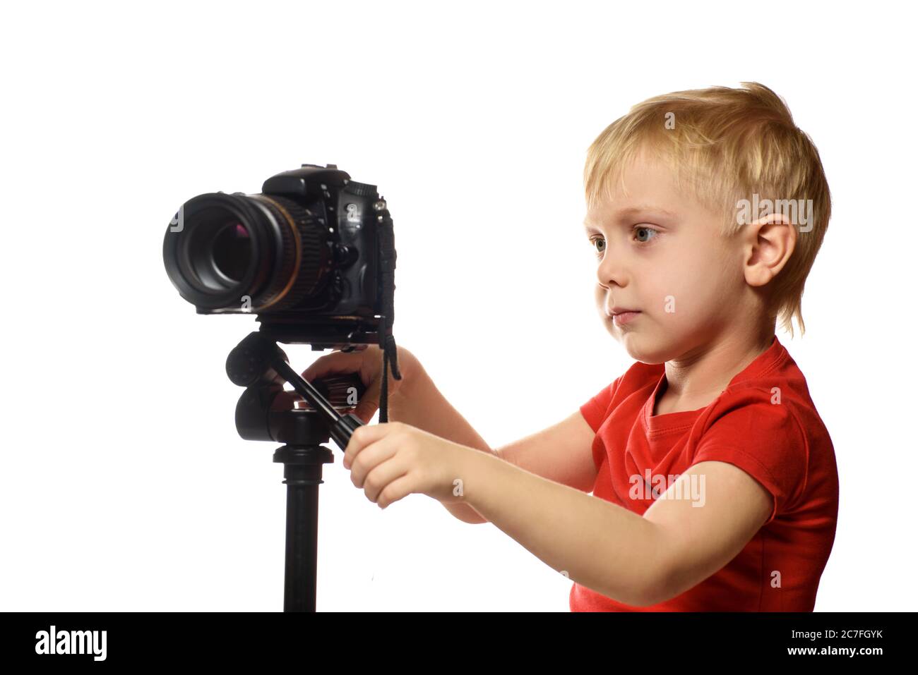 Blond boy shoots video on DSLR camera. Front view. White background, isolate Stock Photo