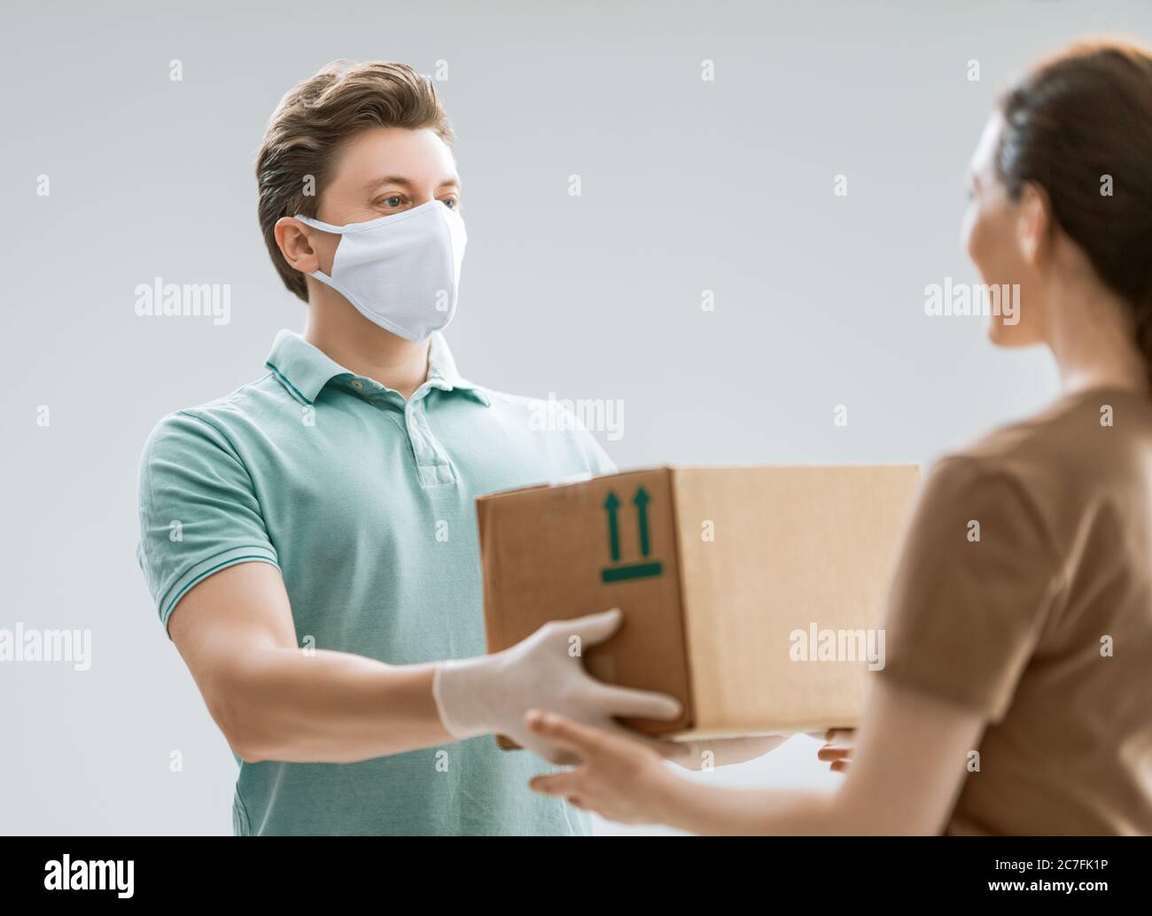 Delivery Man Hand Gloves Holding Package Stock Photo 2180509575